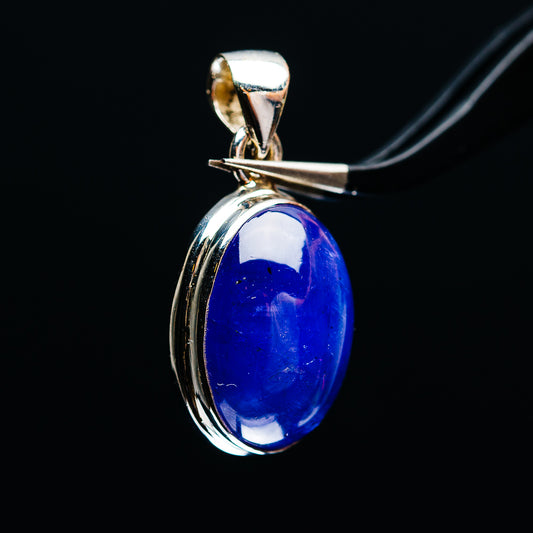 Side view of oval blue tanzanite pendant in sterling silver setting with bail