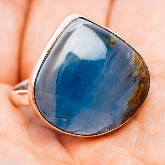 Sterling silver ring with teardrop blue cabochon gemstone, side angle view bezel