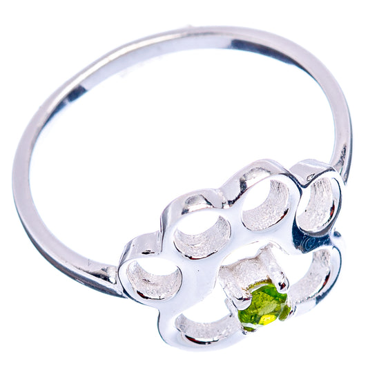 Sterling silver ring with paw motif and round green peridot stone at front