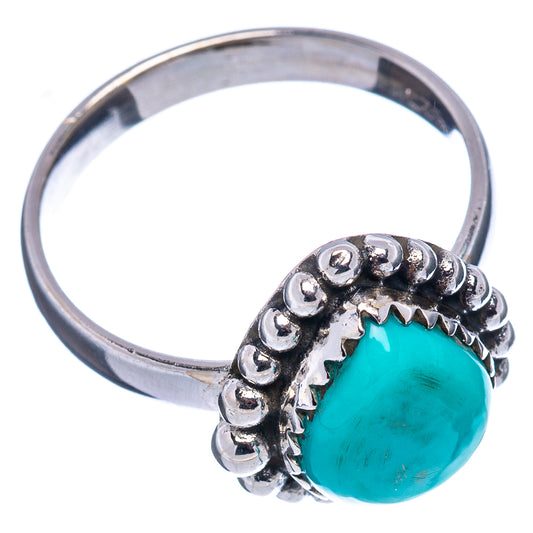 Sterling silver ring with textured bead setting and turquoise oval cabochon