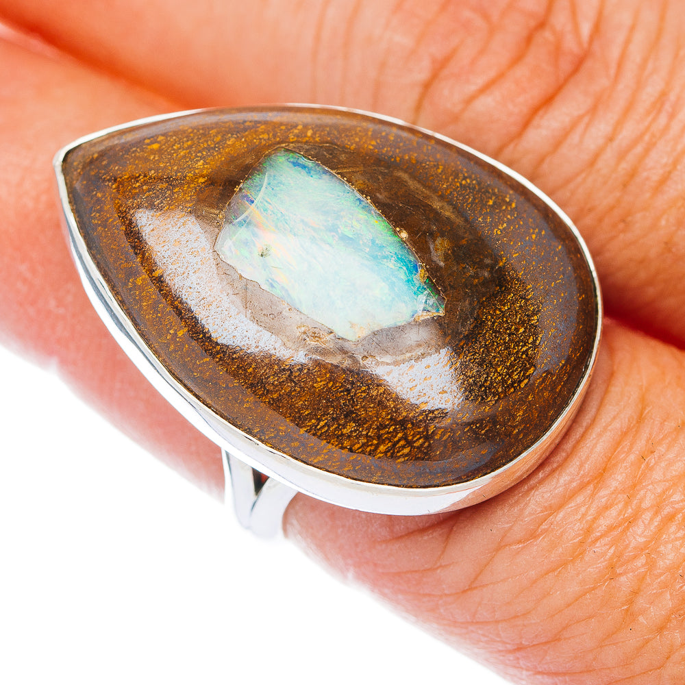 Sterling silver ring with teardrop boulder opal, blue-green center and brown matrix.