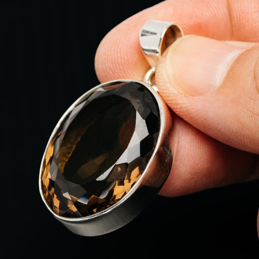 Faceted oval smoky quartz pendant in .925 sterling silver with top bail