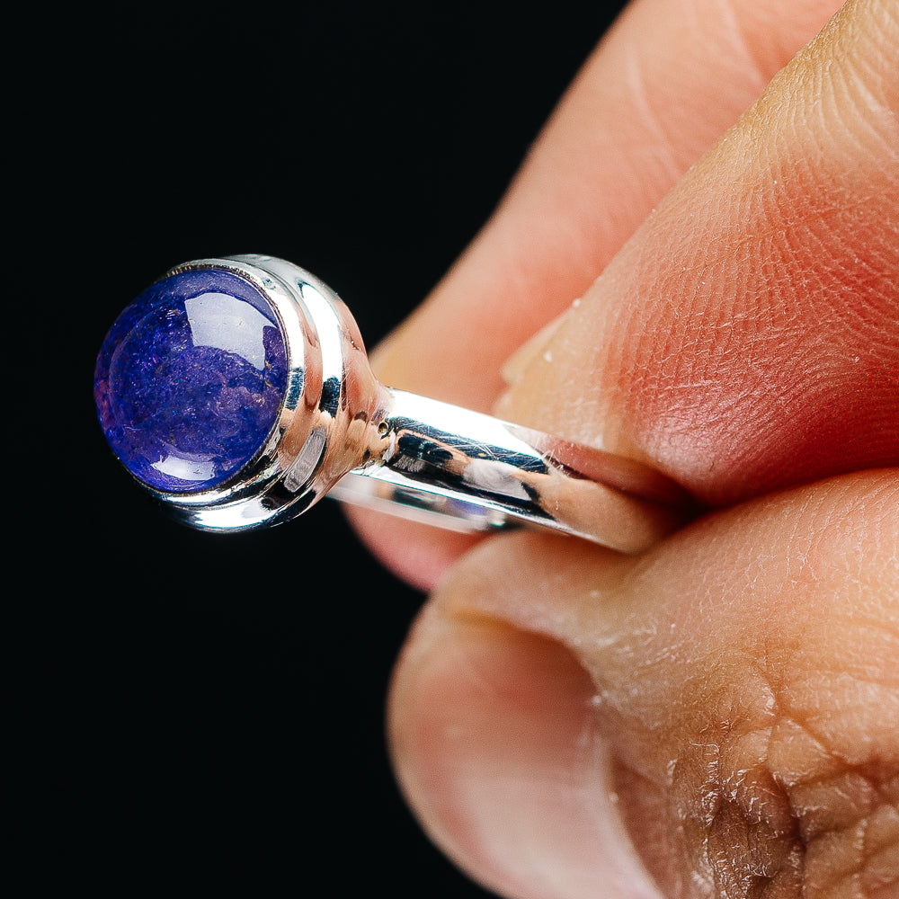 Sterling silver ring with round blue-purple gemstone, shown from the side