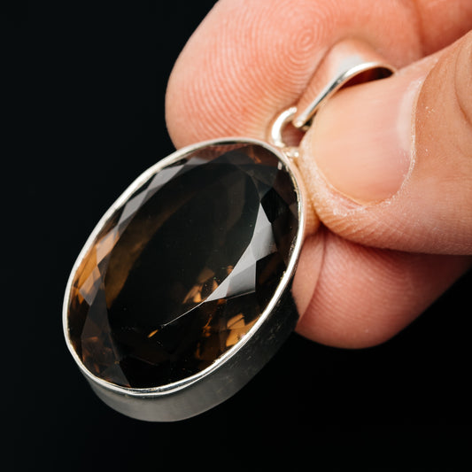 Oval smoky quartz pendant with faceted stone and sterling silver loop bail