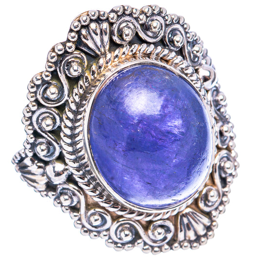 Sterling silver ring with oval blue-violet gemstone, swirling filigree border