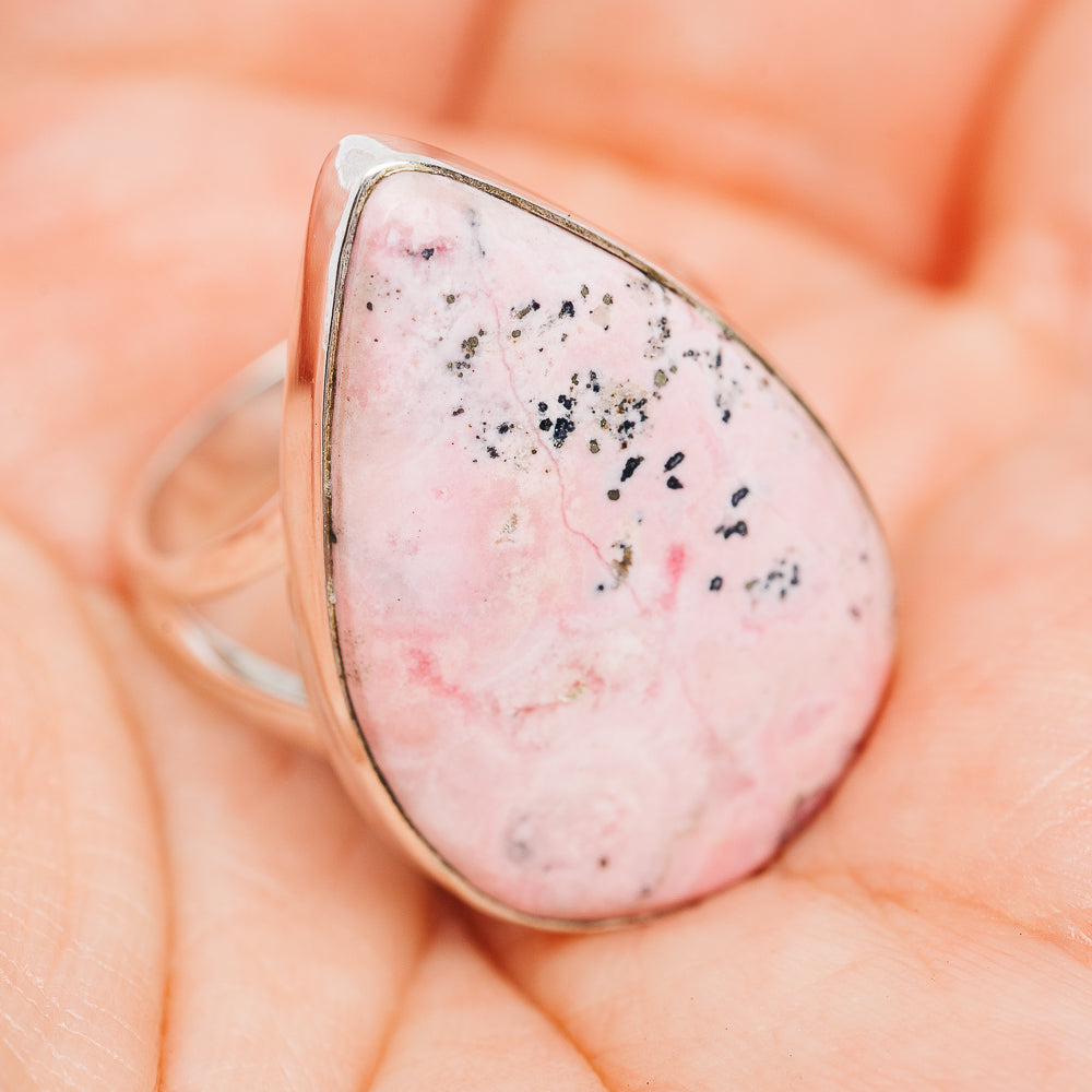 Sterling silver rhodonite ring with teardrop pink cabochon bezel and black mineral flecks