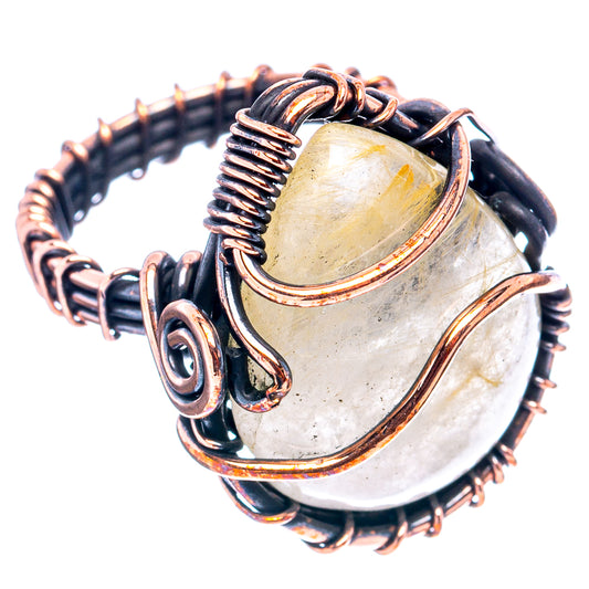 Oxidized copper wire-wrapped oval quartz ring, dark metal coils and prongs.