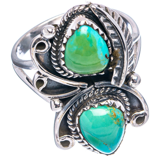 Ornate sterling silver turquoise ring with oval green-blue stones and side settings