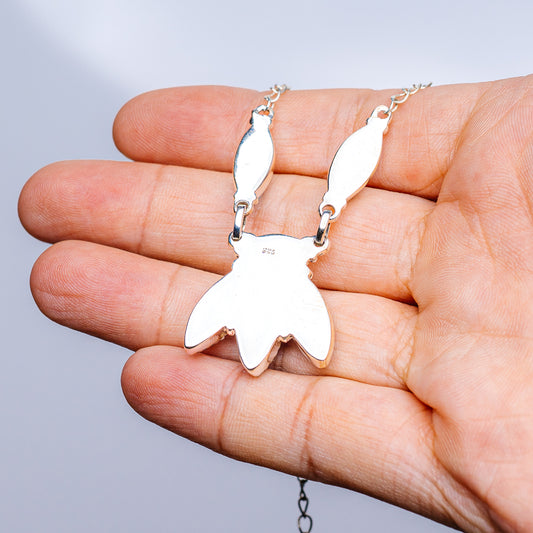 Sterling silver leaf-shaped pendant with chain links, no stones visible
