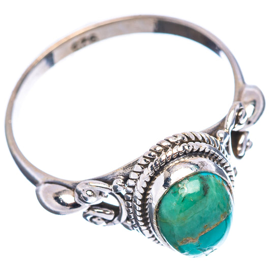 Sterling silver turquoise ring with oval green cabochon, braided bezel, and side scrolls