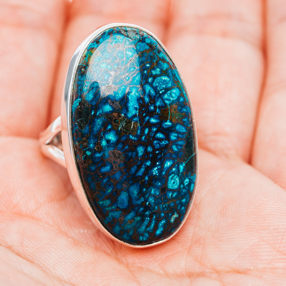 Turquoise-blue oval stone ring in silver bezel, side view