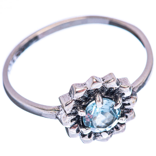 Sterling silver blue topaz ring with decorative halo setting and round gemstone