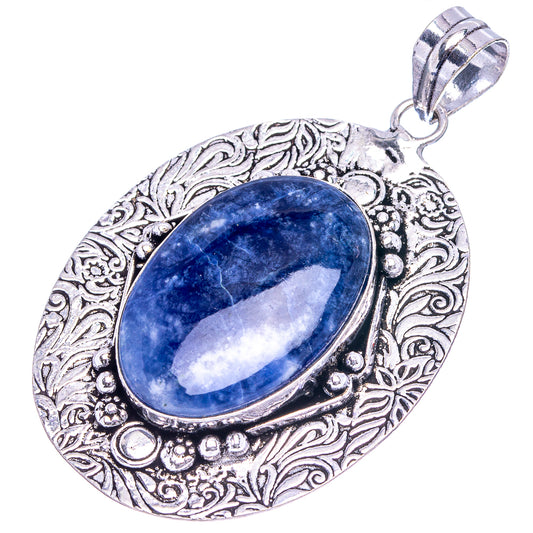 Ornate German silver sodalite pendant featuring oval blue cabochon with decorative border