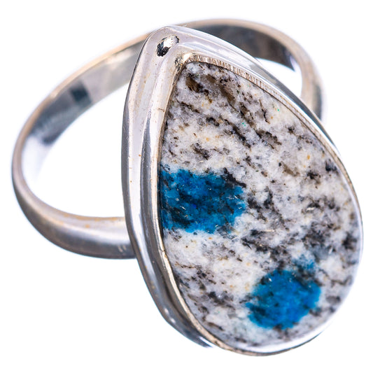 Teardrop azurite cabochon set in sterling silver, blue patches on light stone surface