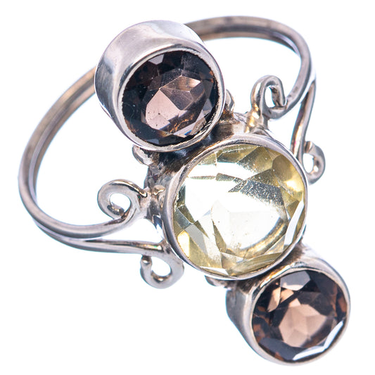 Sterling silver ring with openwork band, round yellow center and two dark bezel-set stones