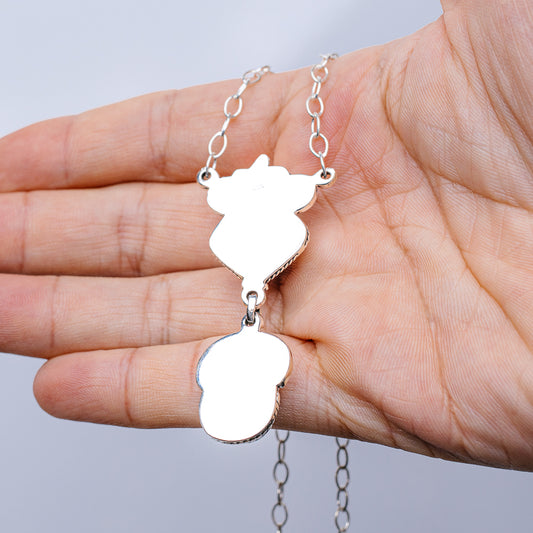Silver chain necklace with two dangling bear-shaped charms, long drop
