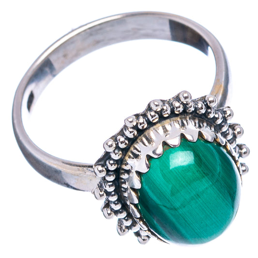 Sterling silver ring with oval green malachite cabochon and textured scalloped bezel