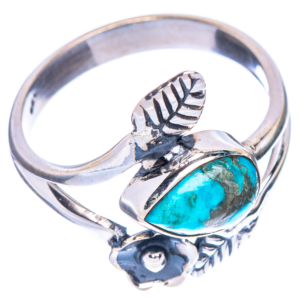 Silver oval turquoise ring with leaf motif band and flower detail at the base