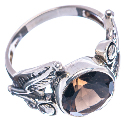 Ornate sterling silver ring with large oval dark gemstone bezel and openwork sides