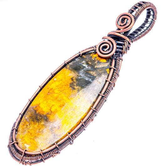 Teardrop jasper wire-wrap pendant with yellow, black, and gray stone; copper spiral bail