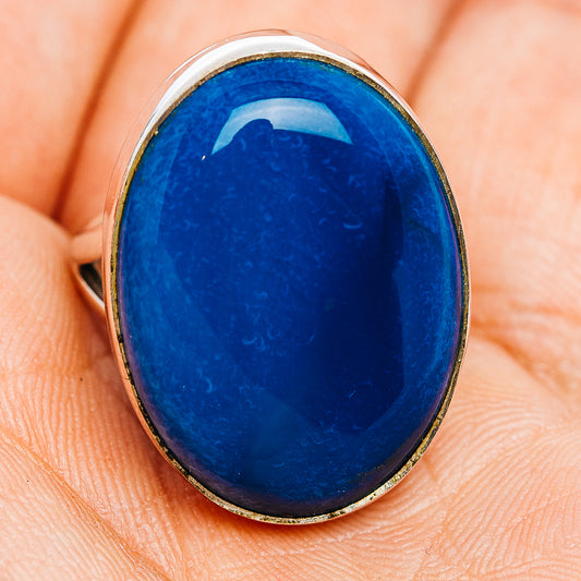 Oval blue opal cabochon ring in polished sterling silver bezel, side view