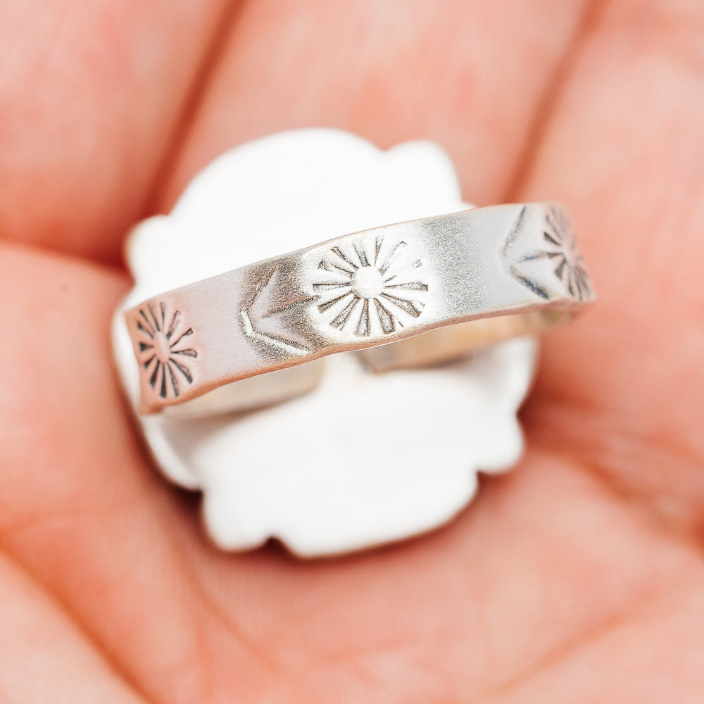 Adjustable sterling silver ring band with engraved sunburst and star patterns