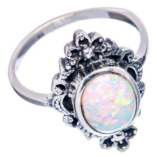 Sterling silver oval lab opal ring with ornate floral bezel and openwork band sides