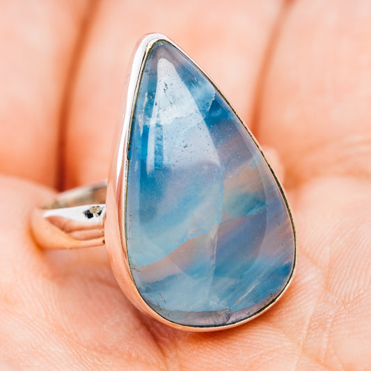 Sterling silver teardrop ring with blue cabochon, bezel-set side view.
