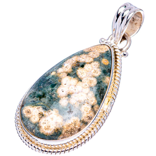 Teardrop ocean jasper pendant with blue-green and cream speckled stone, silver bail.