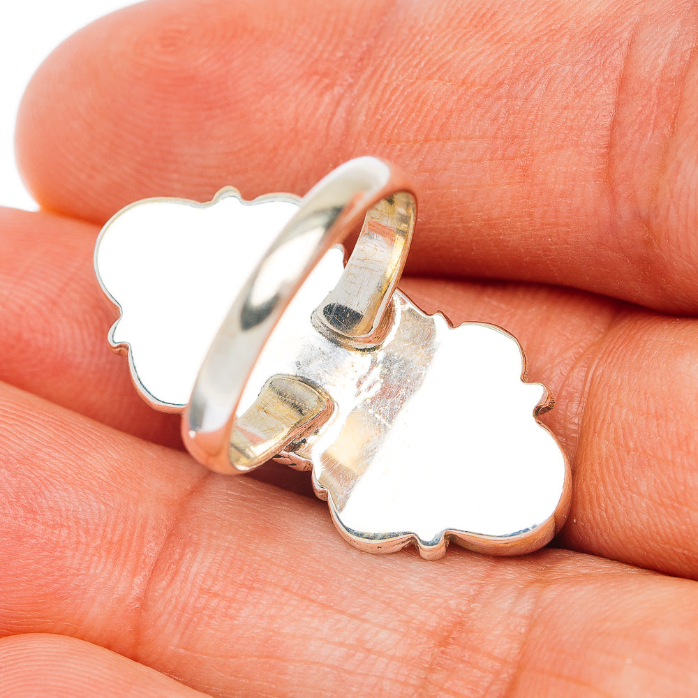 Sterling silver ring side view with openwork clover-shaped band and prong setting