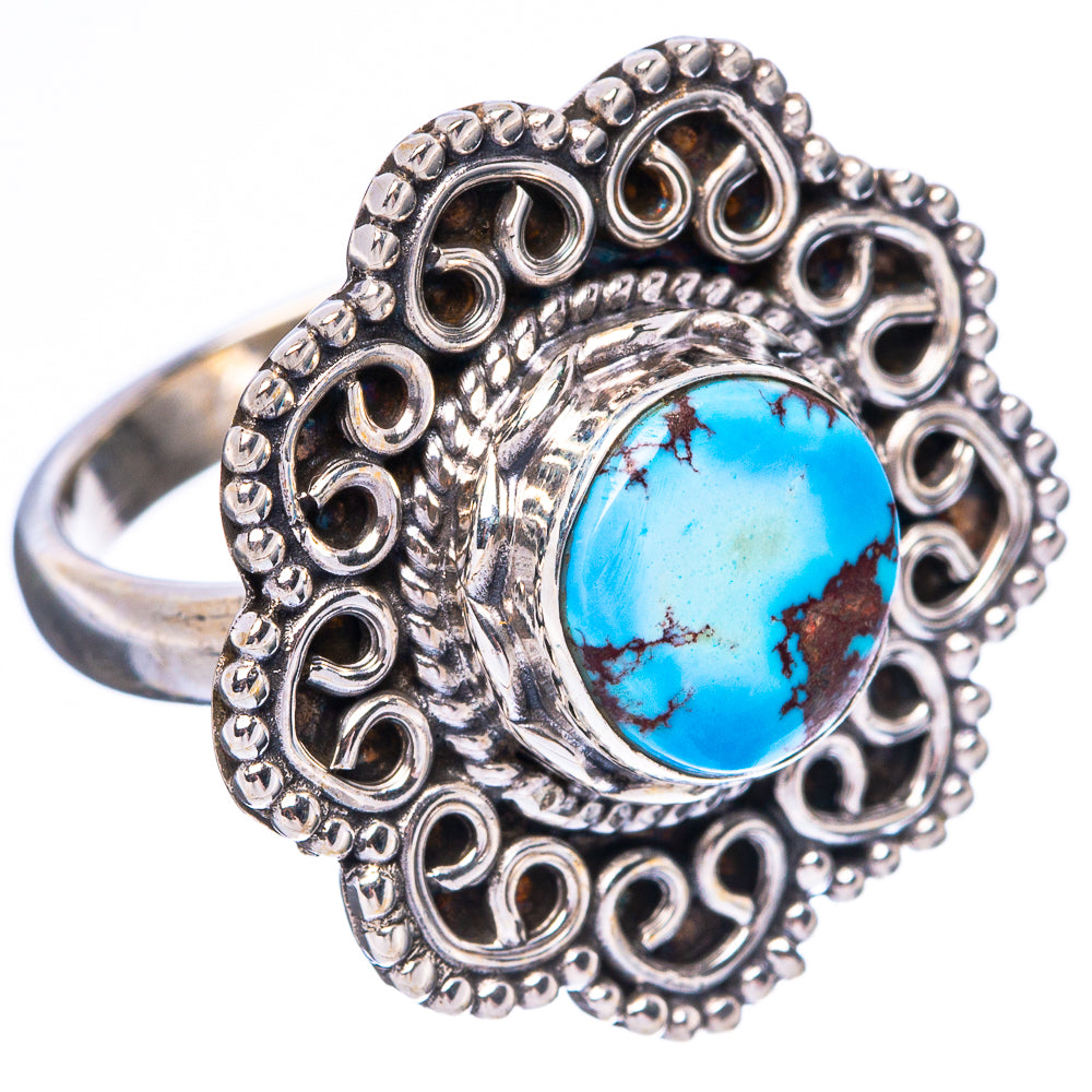 Sterling silver ring featuring blue turquoise cabochon and heart-like filigree border