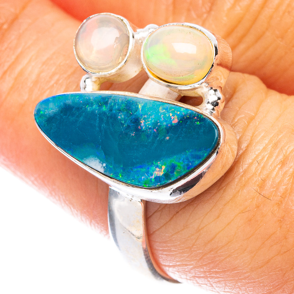 Sterling silver opal doublet ring with oval blue-green center and two round opal accents