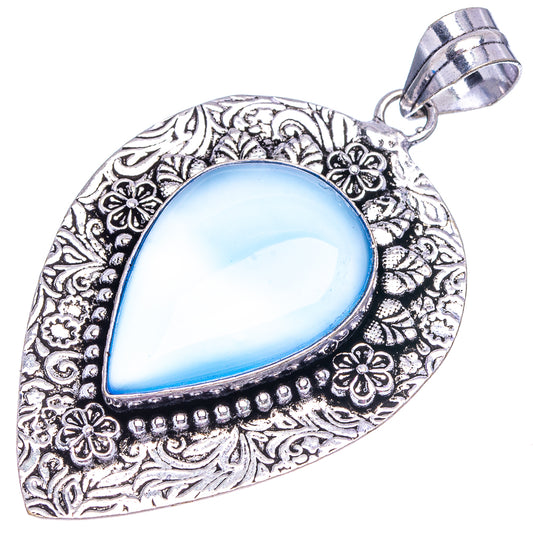 Blue teardrop pendant with German silver frame and decorative floral filigree