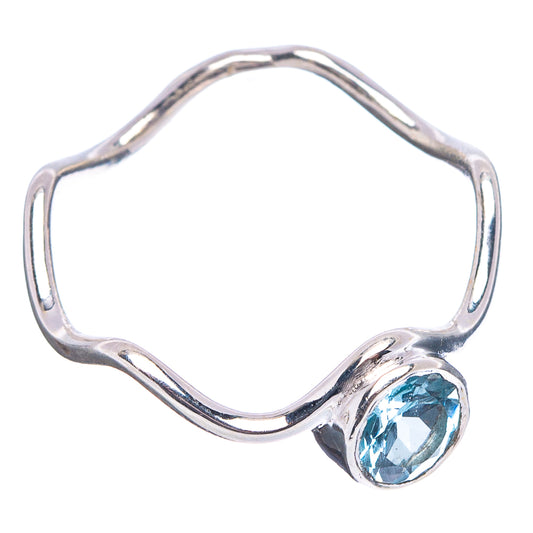 Sterling silver openwork ring with oval blue topaz gemstone on a wavy band