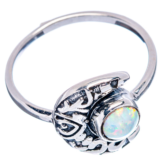 Sterling silver opal ring with oval bezel, lab opal, and carved side scrollwork