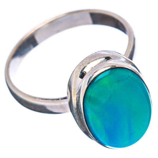 Sterling silver oval opal ring with teal gemstone, angled view of band.