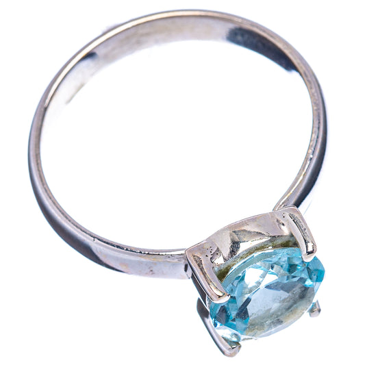 Sterling silver topaz ring with faceted light blue gemstone, side view with band
