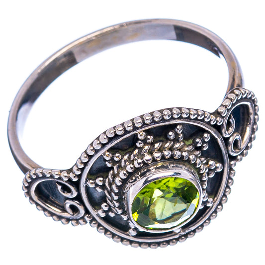 Sterling silver peridot ring with round green gemstone and detailed scroll side setting