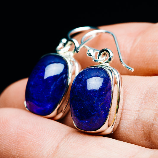 Oval tanzanite drop earrings, blue stones in silver bezels with curved hooks