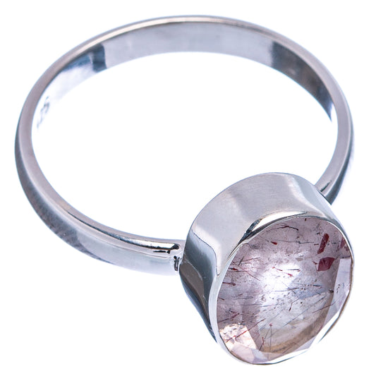 Sterling silver ring with heart-shaped clear stone, raised bezel, red flecks