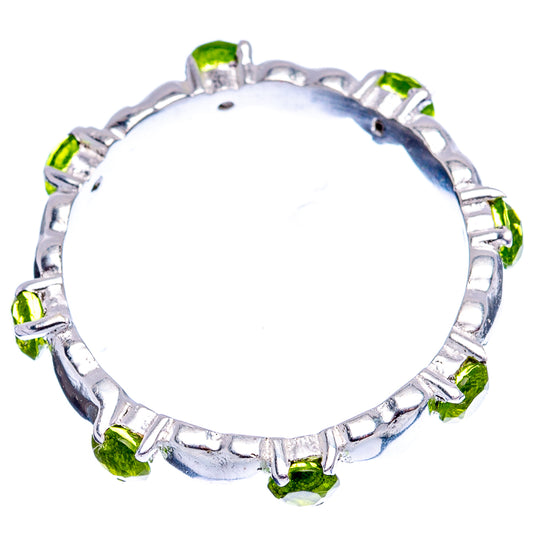 Sterling silver ring with heart setting and round green peridot-style stones