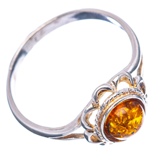Sterling silver amber ring with oval floral bezel and warm honey orange stone