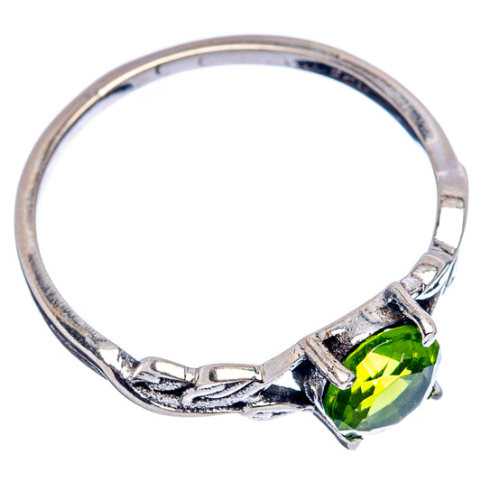 Sterling silver ring with textured band and green peridot oval gemstone at side