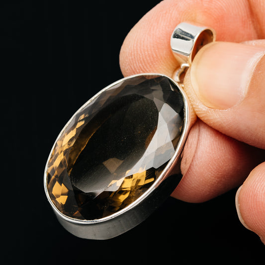 Smoky quartz oval pendant with faceted gemstone in silver bezel, open bail