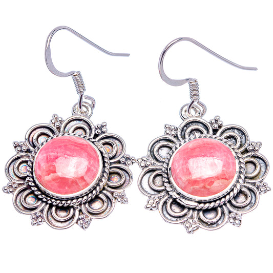 Pair of sterling silver filigree earrings featuring bright pink round cabochon stones.