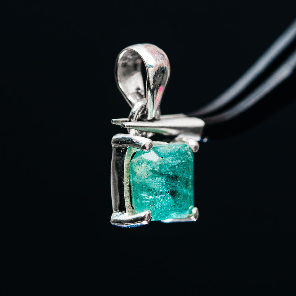 Sterling silver pendant with emerald-green rectangular gemstone in prong setting