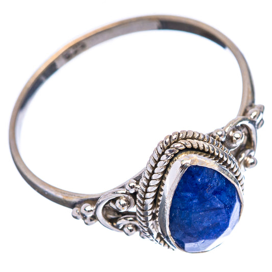 Sterling silver ring featuring oval blue gemstone, rope border, and curled filigree accents
