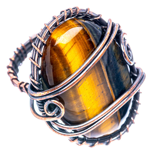 Wire-wrapped tiger’s eye oval cabochon ring with braided oxidized copper frame