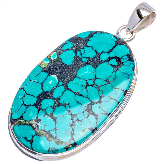 Turquoise oval stone pendant in polished sterling silver, showing detailed black veining