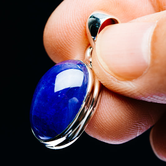 Side view oval tanzanite-blue pendant with sterling silver bail and bezel setting